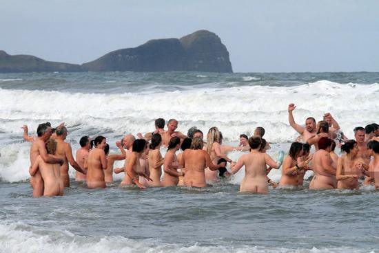 **CONTAINS NUDITY** 400 people defied the cold weather to take part in a record breaking skinny dipping event at Llangennith Beach, Gower Peninsula near Swansea South Wales, United Kingdom